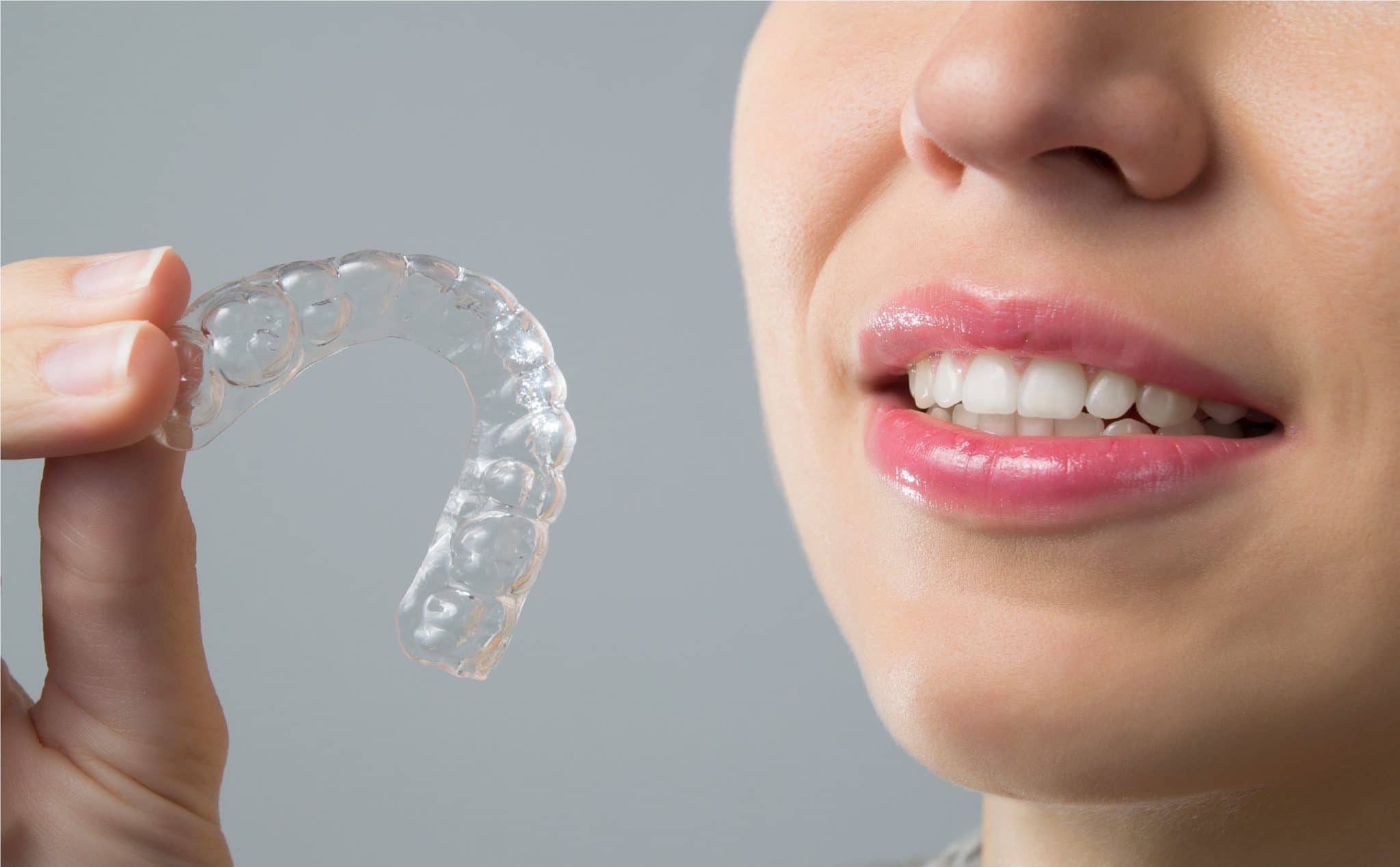 Smiling Woman with silicone trainer. Invisible braces