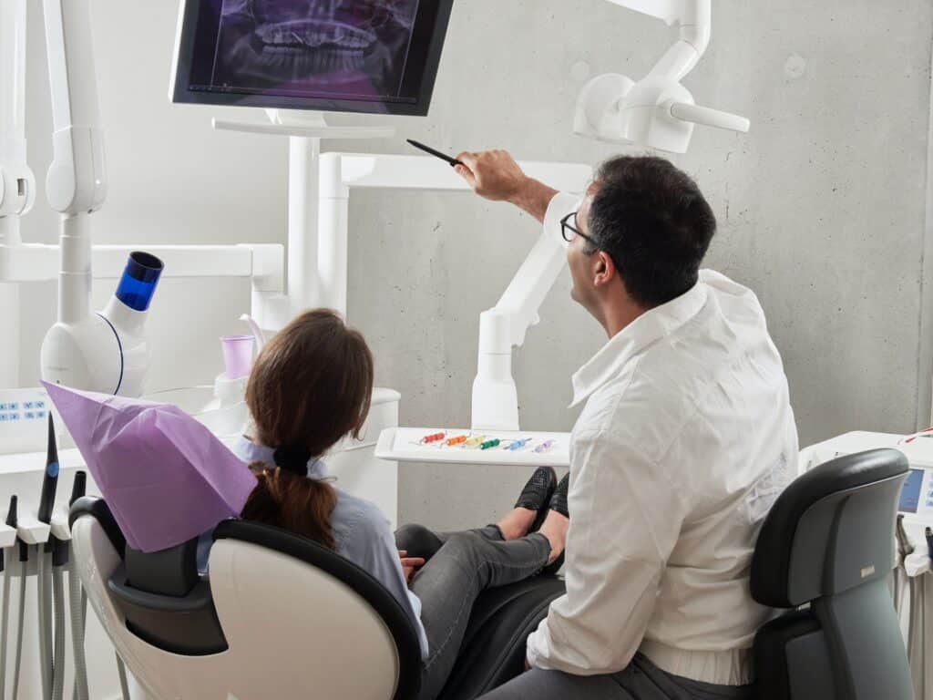 dentist showing patient mouth xray