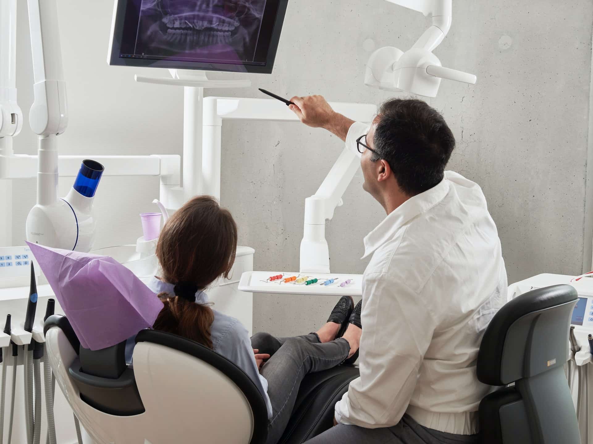 dentist showing patient mouth xray