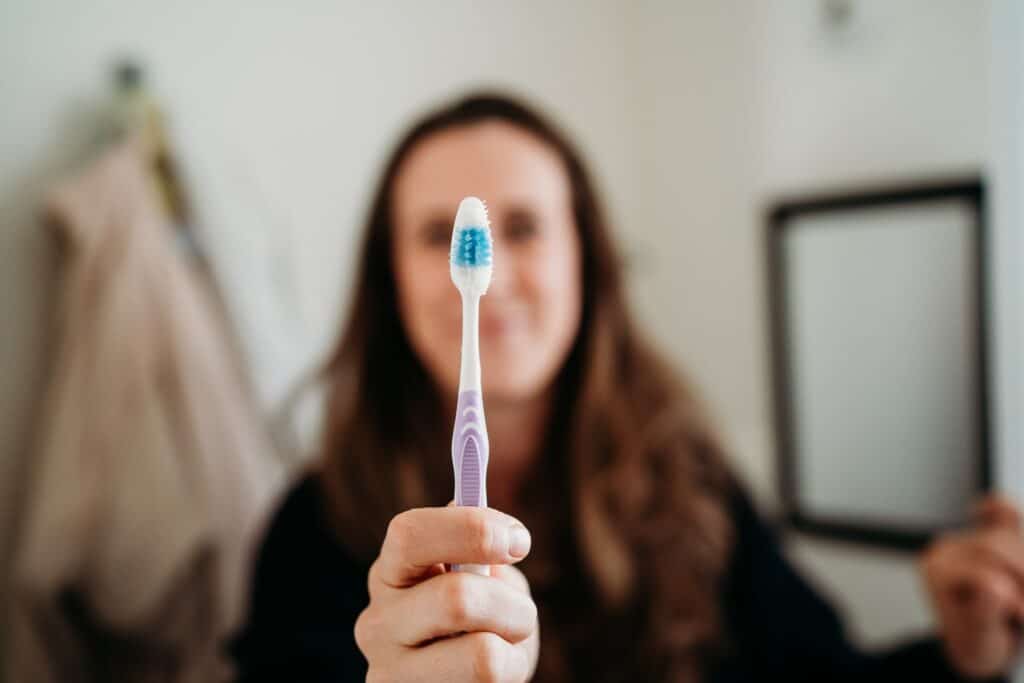 woman holding a toothbrush