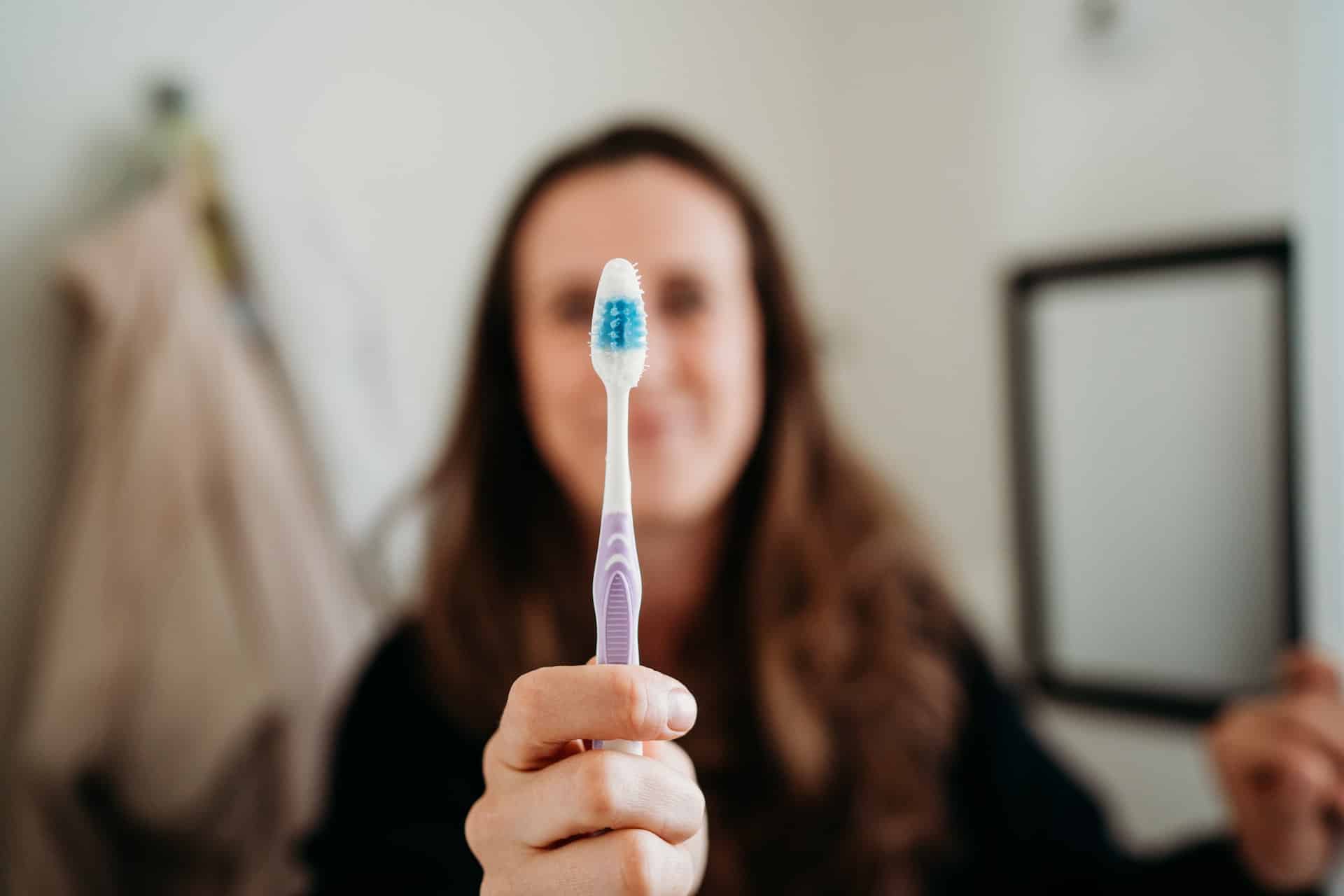 woman holding a toothbrush