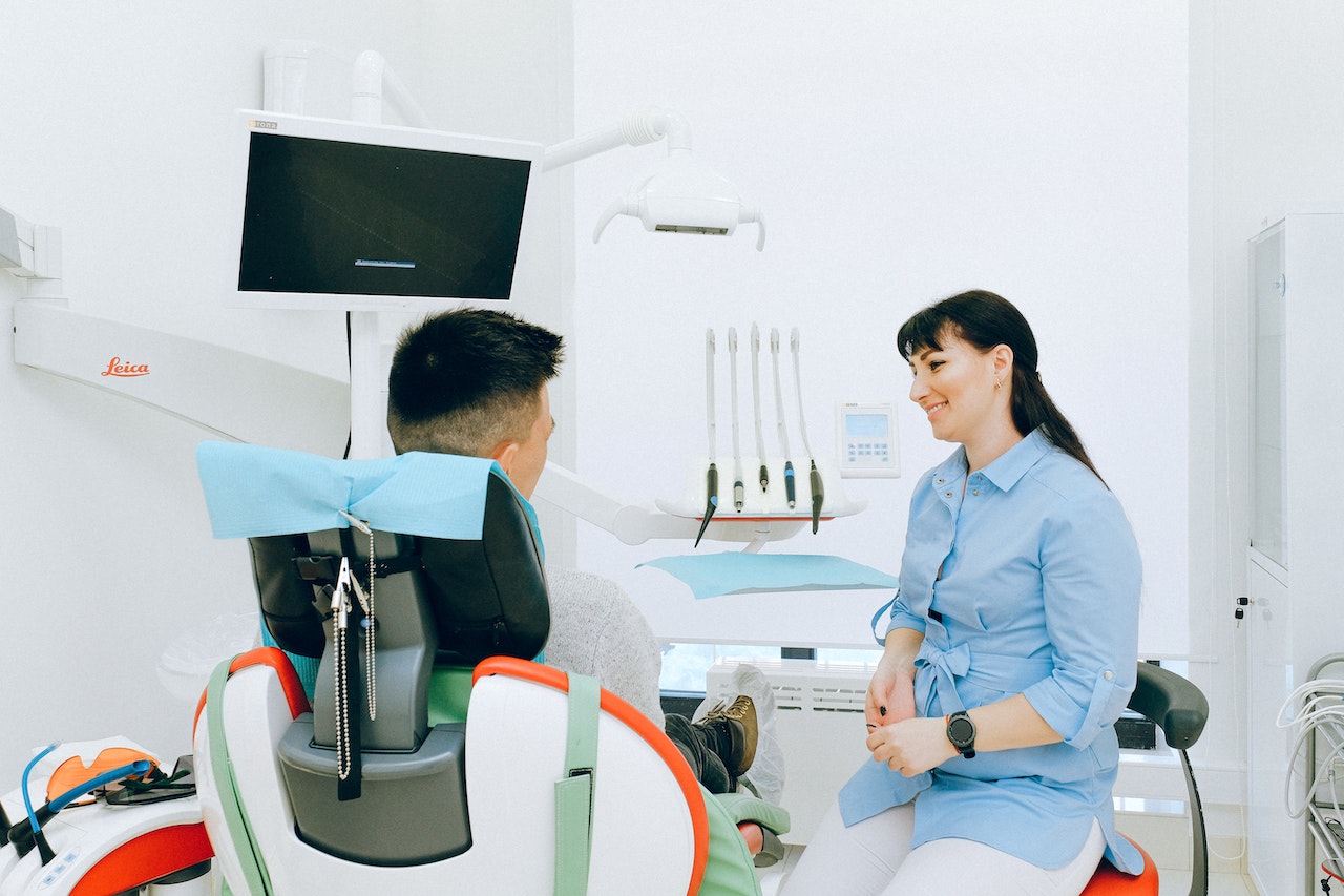 man talking to dentist