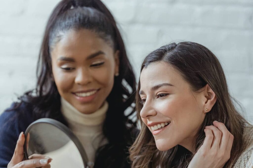 women smiling in the mirror
