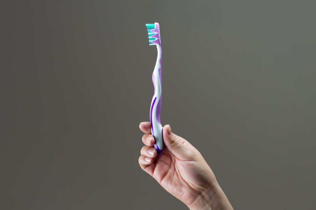 holding a toothbrush
