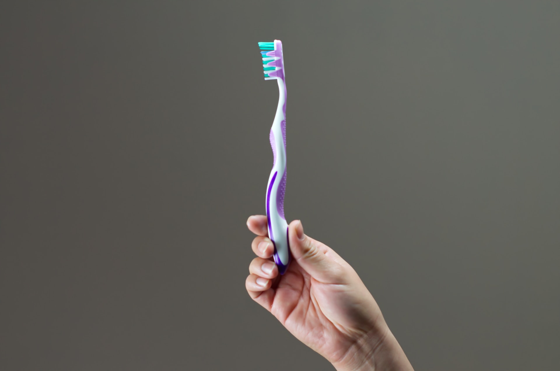 holding a toothbrush