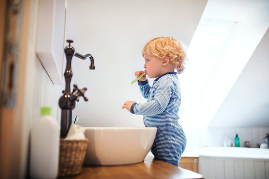 child brushing teeth