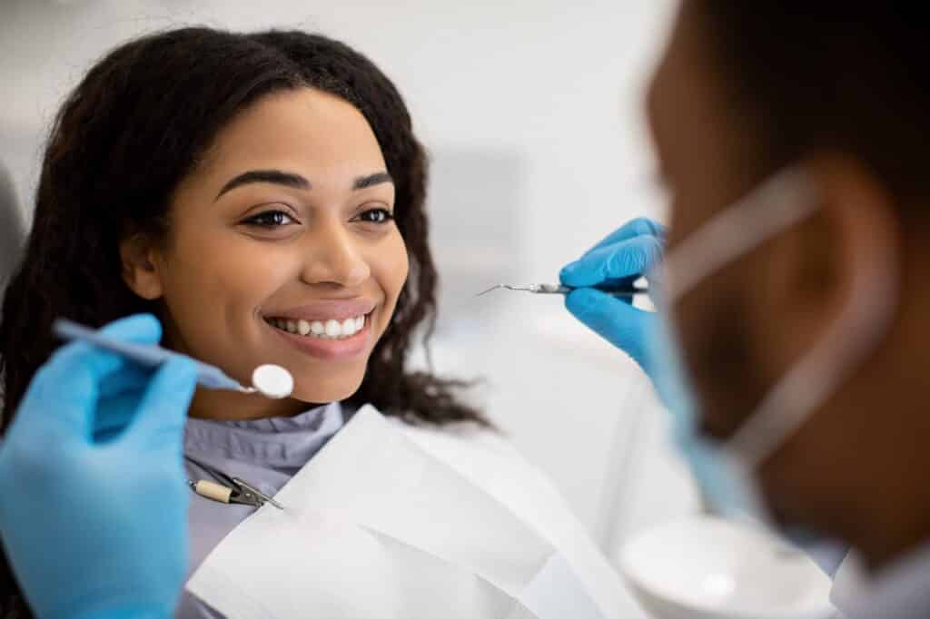 smiling woman sitting at dentist