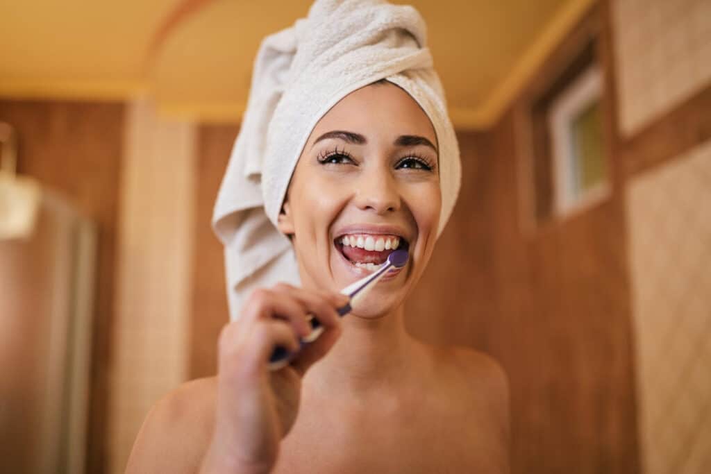 woman brushing teeth