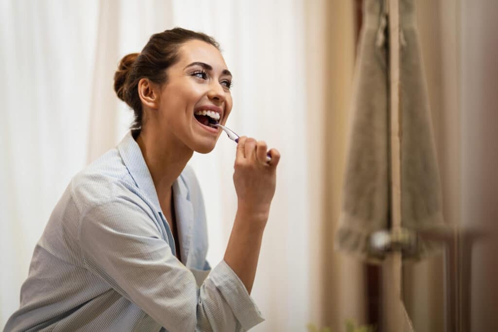woman brushing teeth