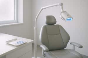Teeth-whitening treatment room with a chair and whitening lamp