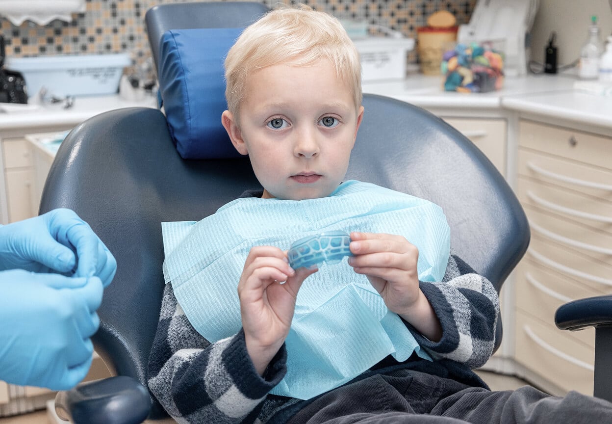 A child at a dental appointment with a hygienist