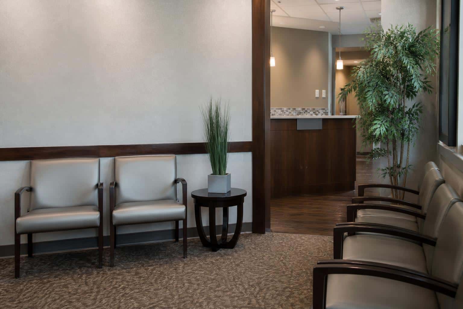 Quiet dental reception area with empty chairs