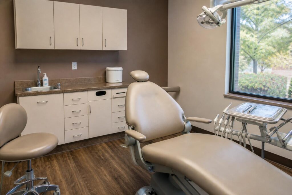 Empty dental emergency treatment room with a chair, tray, and small storage container on the counter