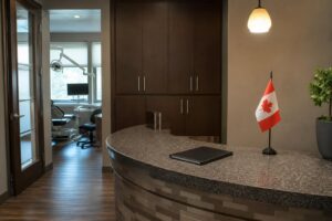 Empty dental office front desk area with a closed folder and a small Canadian flag desk accessory